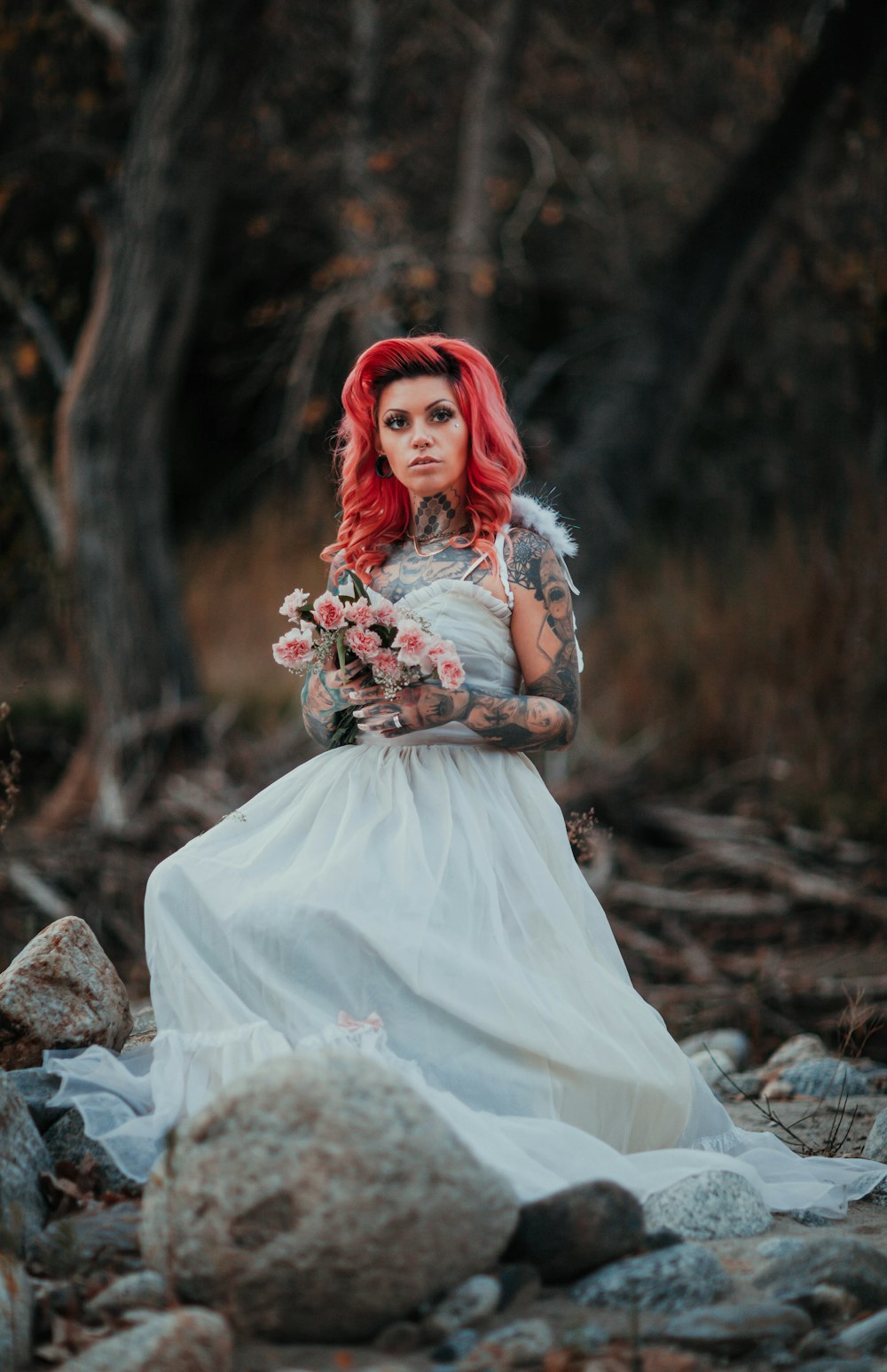 woman in white dress sitting on rock