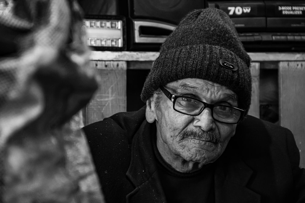 man in black knit cap and black framed eyeglasses