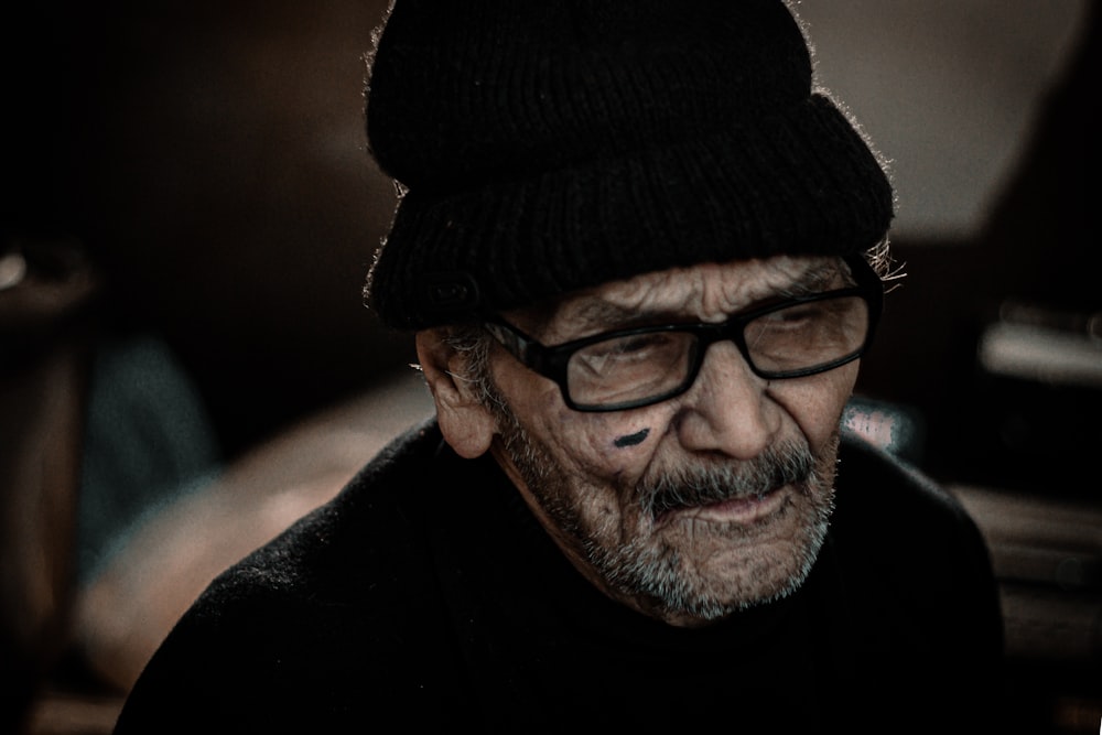 man in black knit cap and black framed eyeglasses