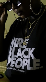 person wearing black and white crew neck t-shirt