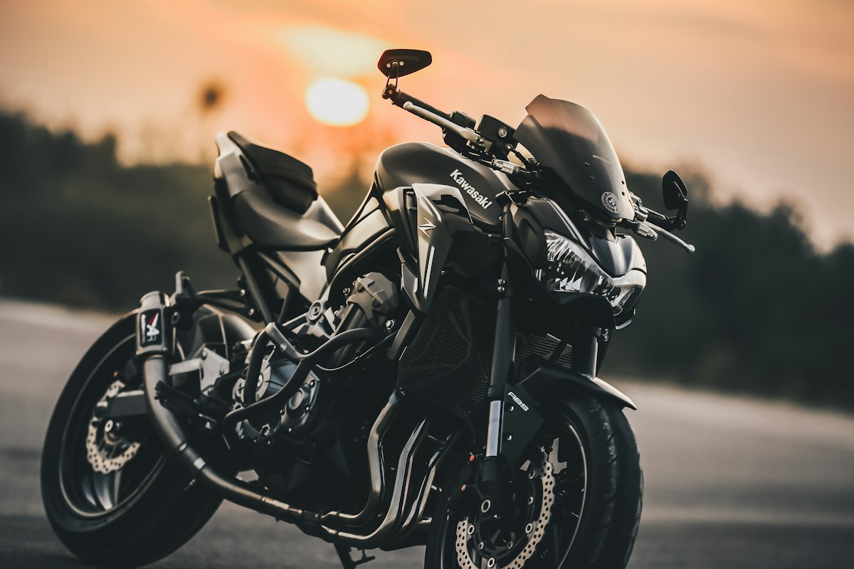 Black motorcycle parked outdoors at sunset