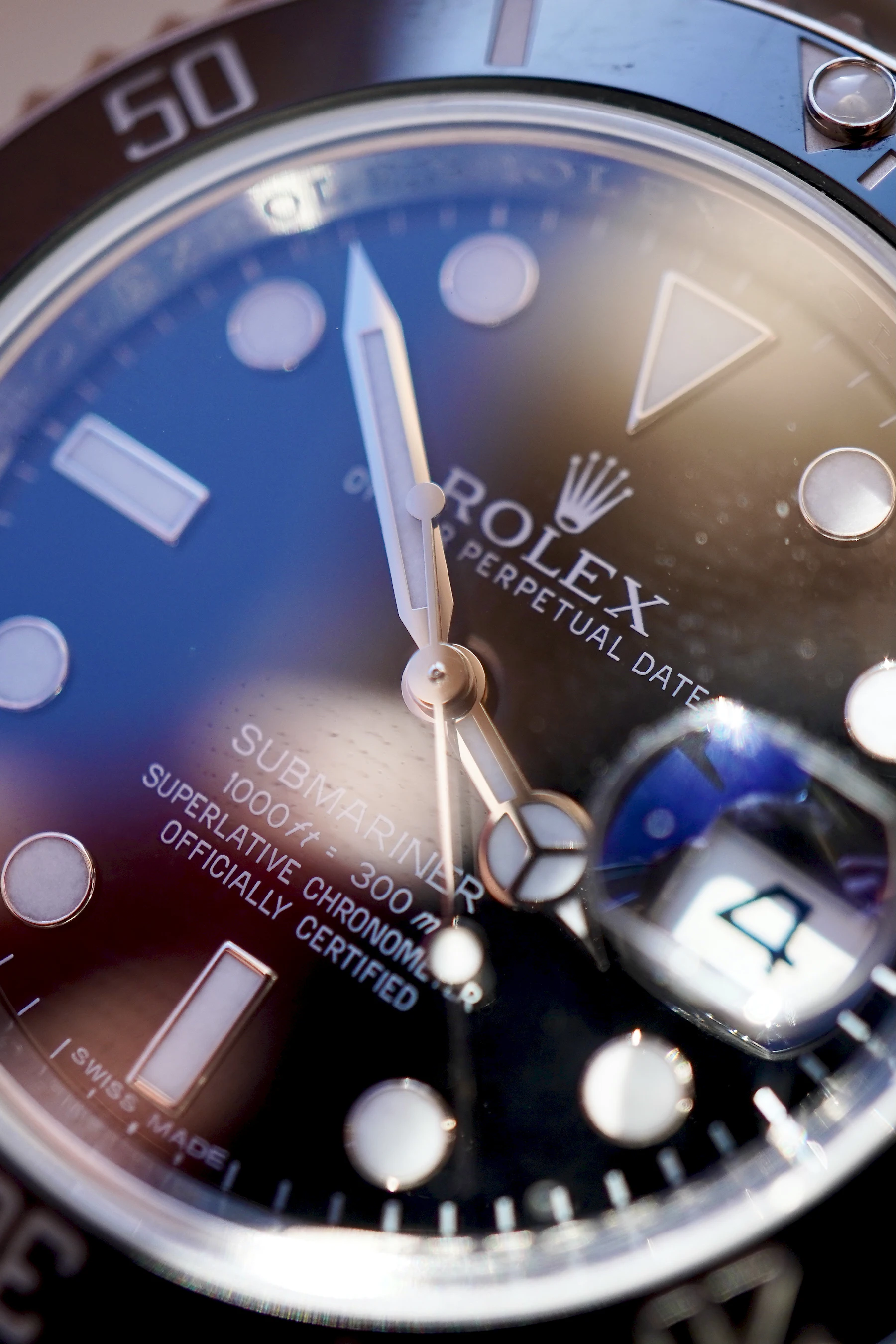 A blue and silver analogue watch, close up