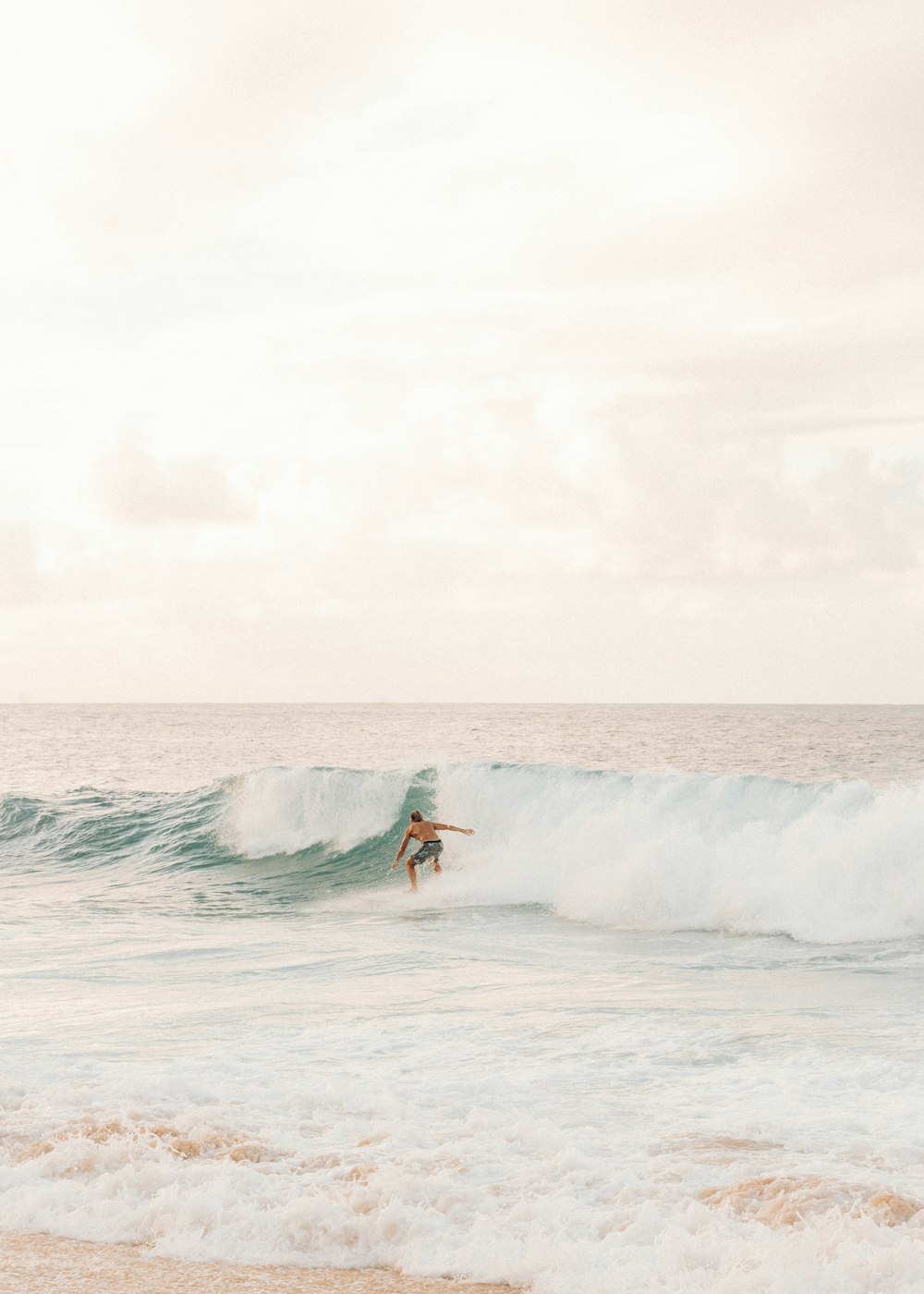 man surfing on sea waves during daytime