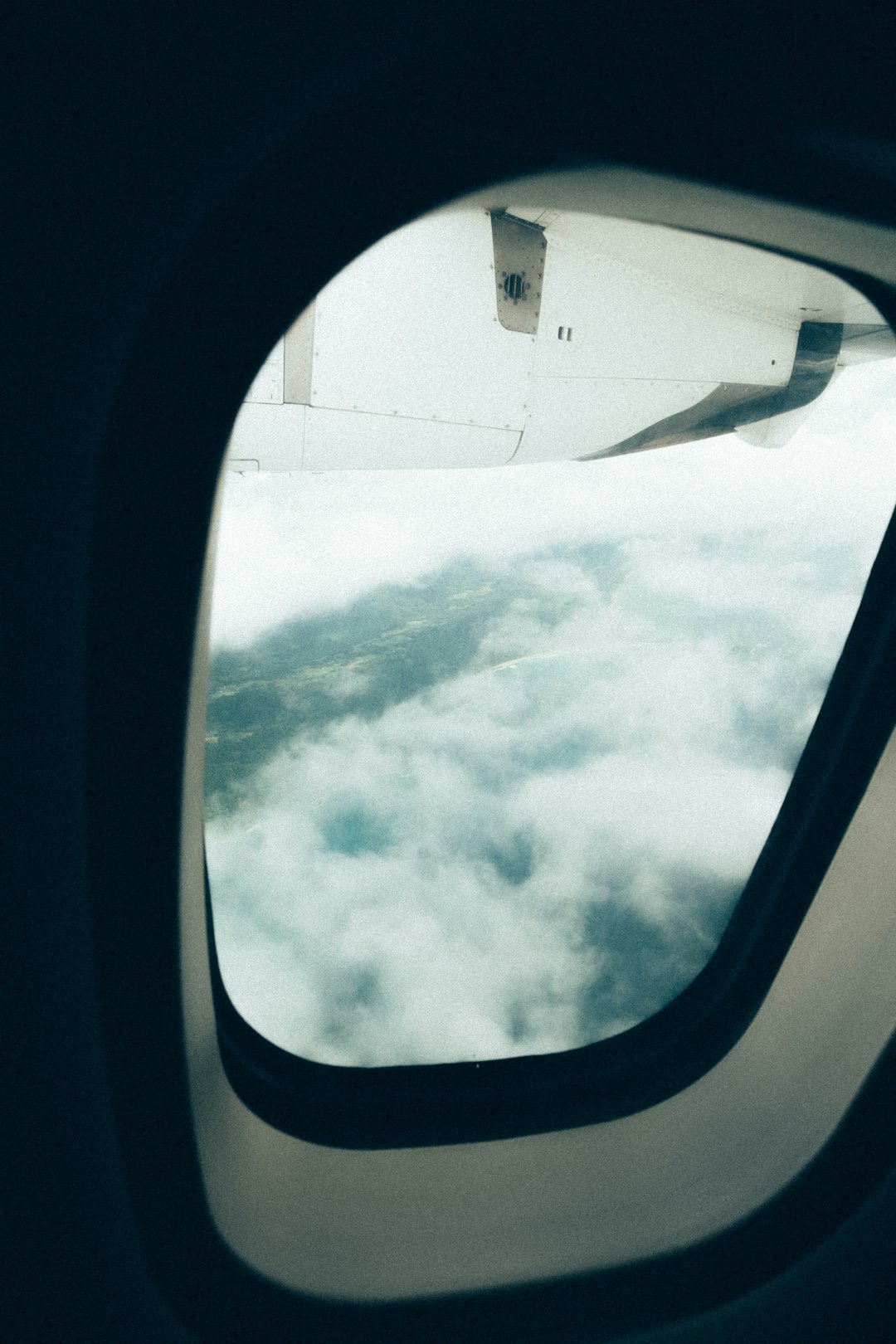 airplane window view of clouds during daytime