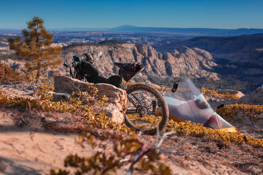 black and white mountain bike on brown rocky mountain during daytime