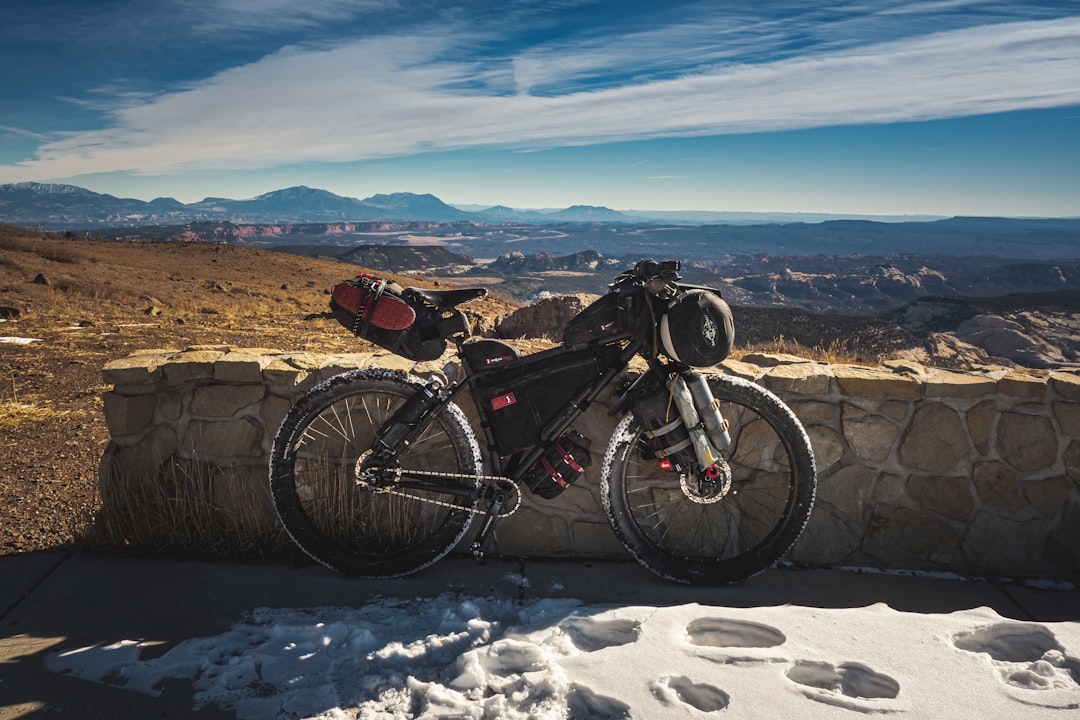 black and red mountain bike on snow covered ground during daytime