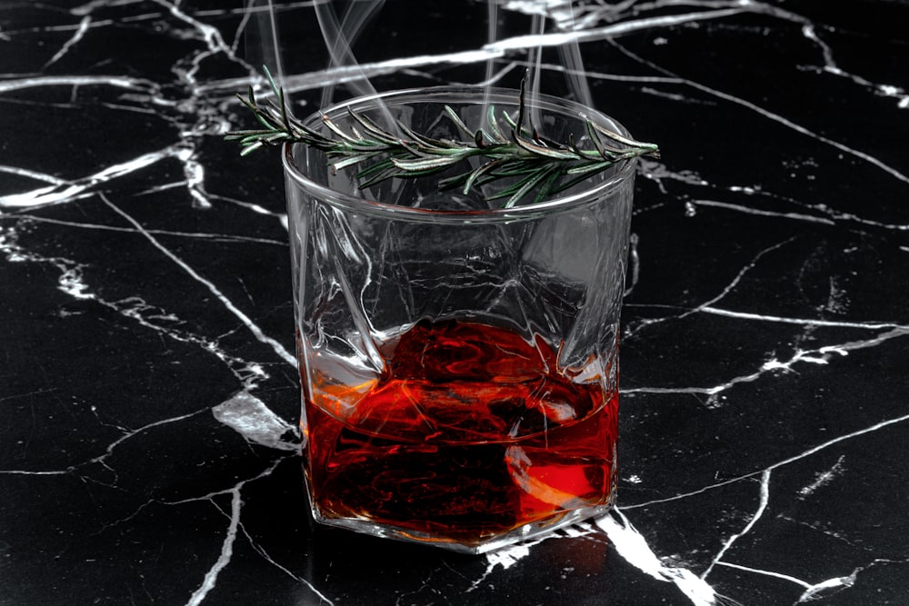 clear drinking glass with red liquid