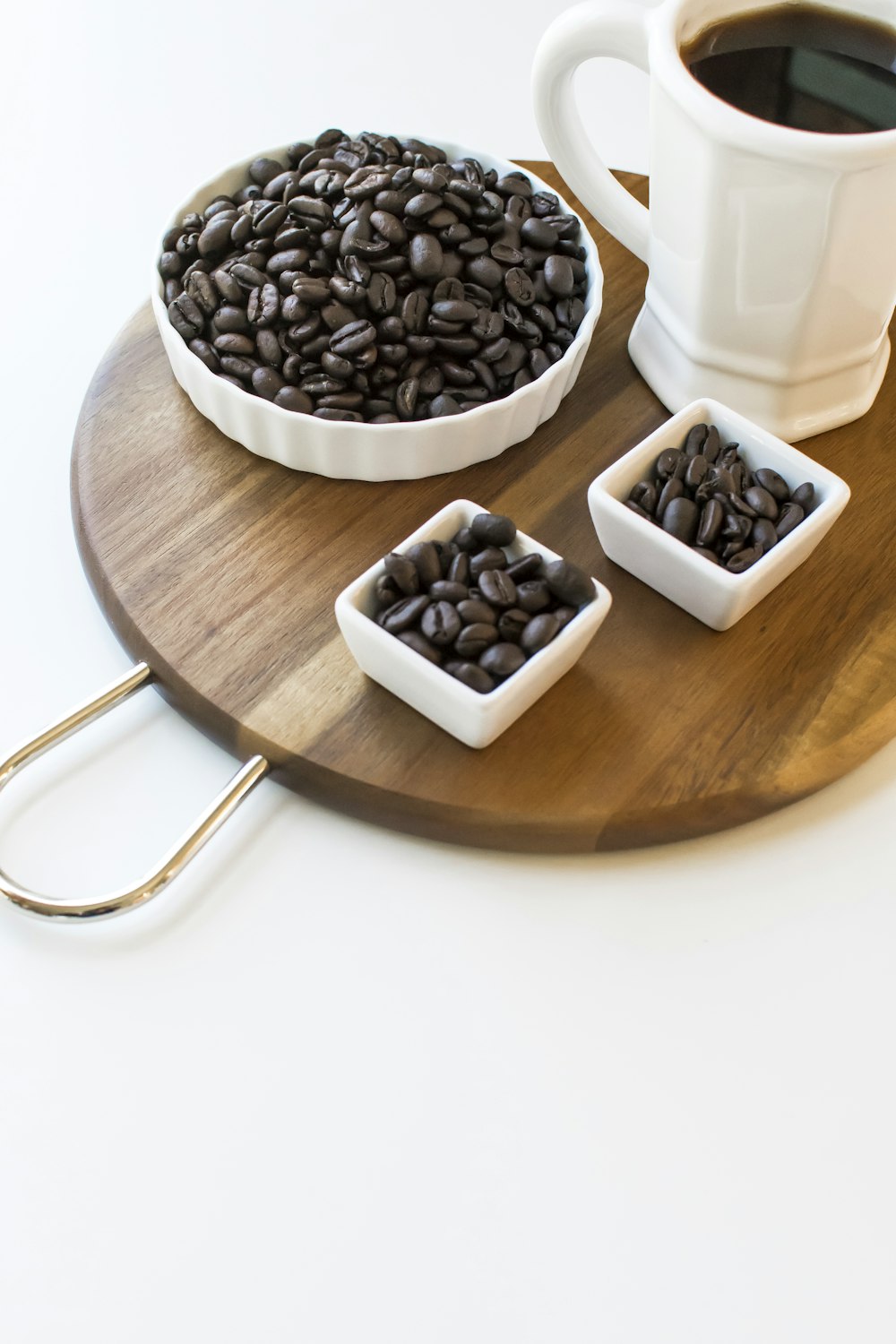 black and white ceramic mugs on brown wooden table