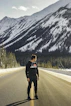 man in black jacket standing on road during daytime