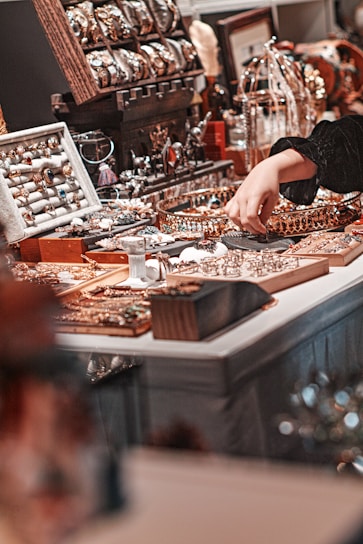 person in black shirt standing in front of brown wooden table with brown and white wooden