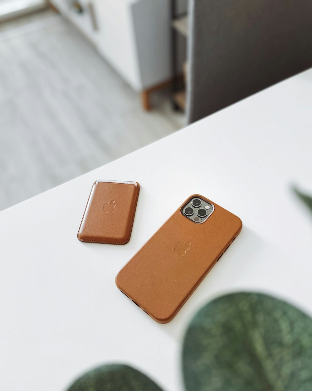 orange iphone case on white table