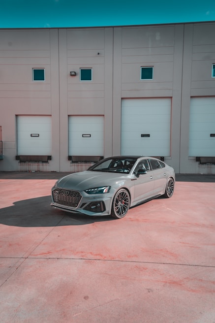 A sleek foreign car parked in front of the All Foreign Parts Inc. building