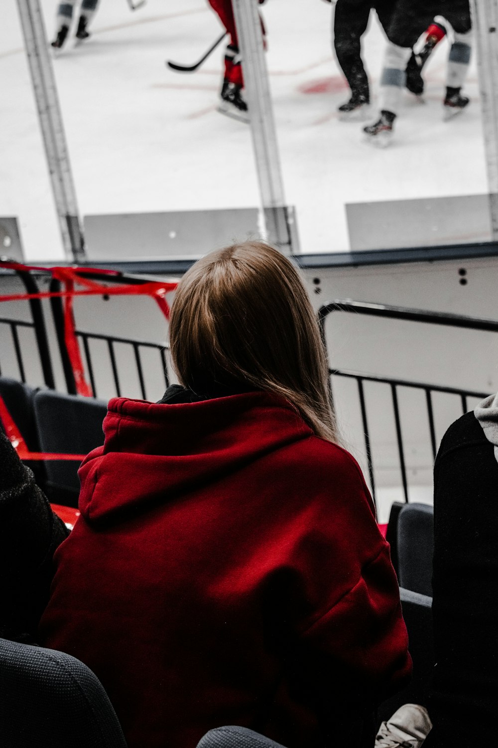 woman in red hoodie sitting on black chair