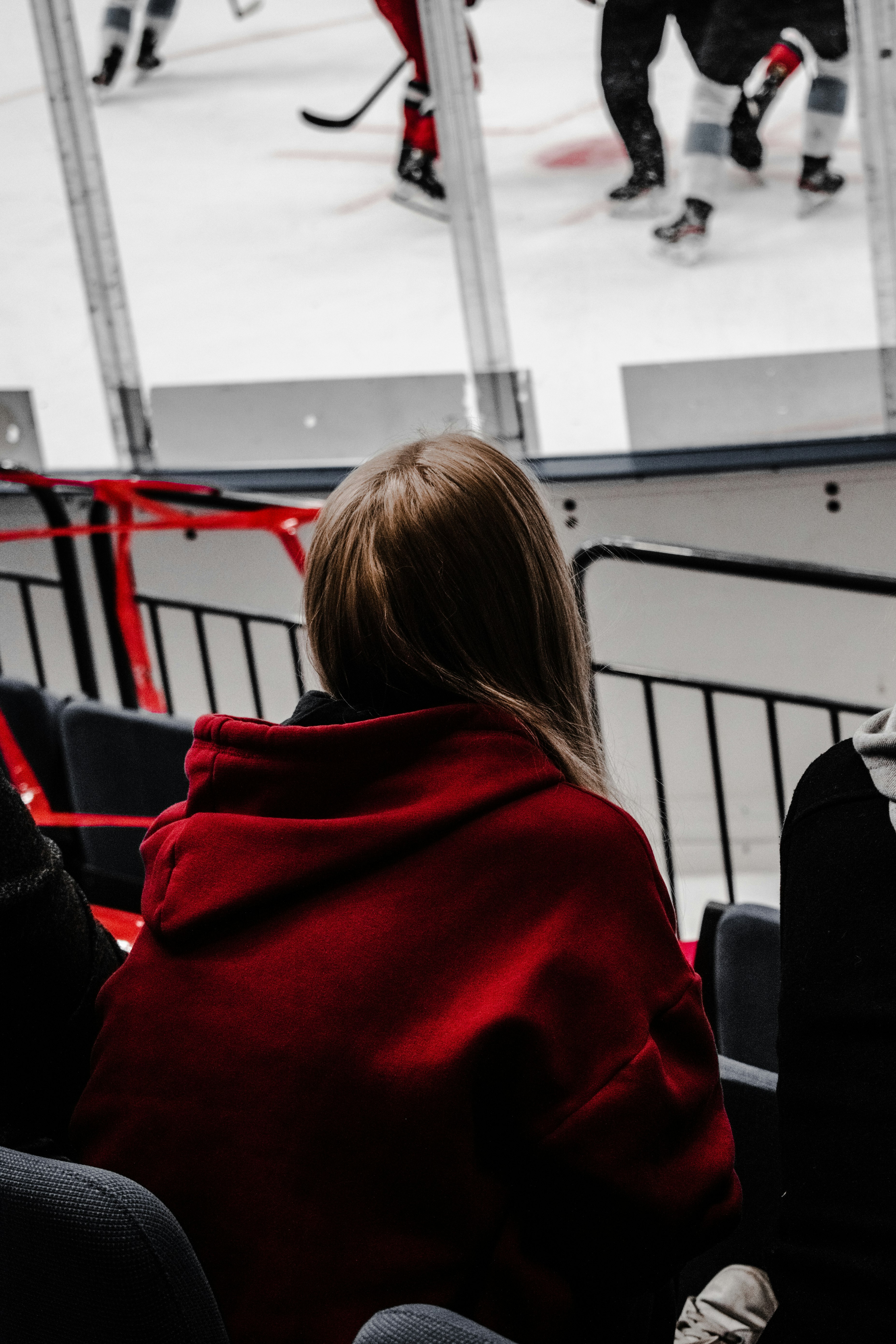 woman in red hoodie sitting on black chair