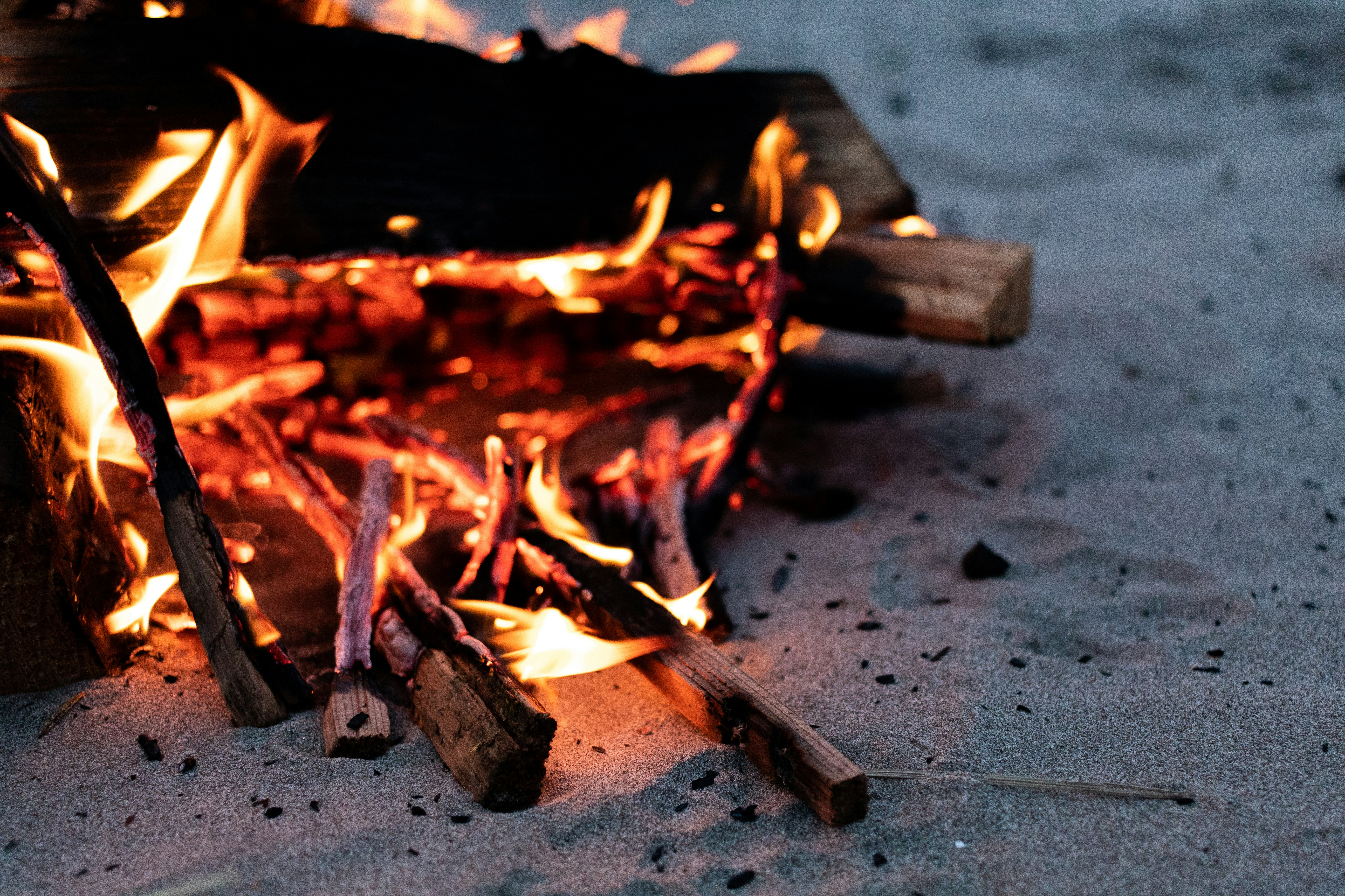 fire on brown wooden plank