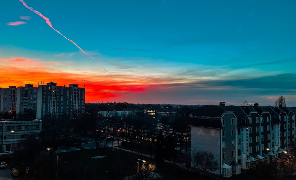 city skyline under orange and blue sky during sunset