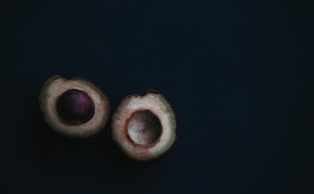 2 brown round cookies on black surface