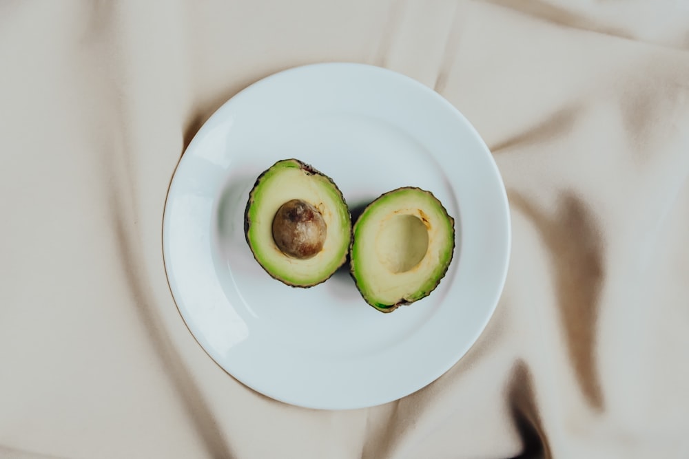 sliced green fruit on white ceramic plate