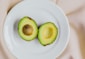 sliced avocado fruit on white ceramic plate