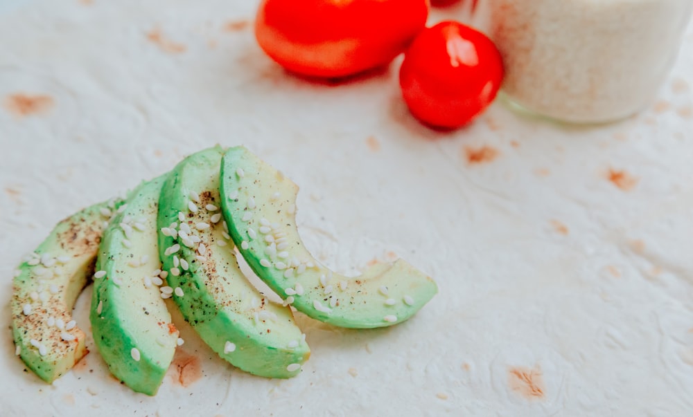 sliced cucumber on white surface