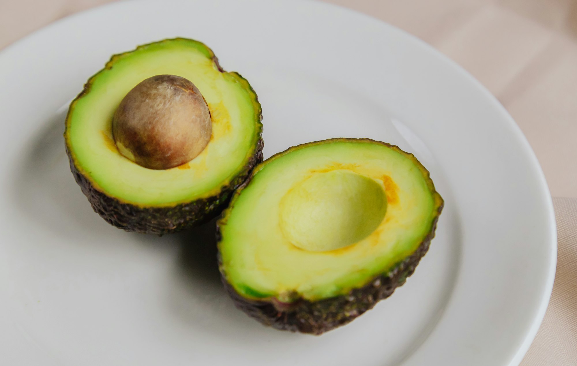 Fresh avocado on a white plate. Top view