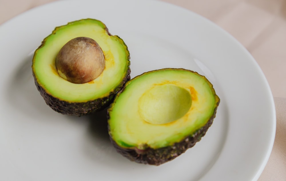 sliced avocado fruit on white ceramic plate