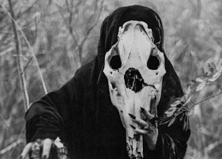 person in black and white skull mask