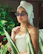 A happy customer smiling post spa treatment with a serene background of plants.