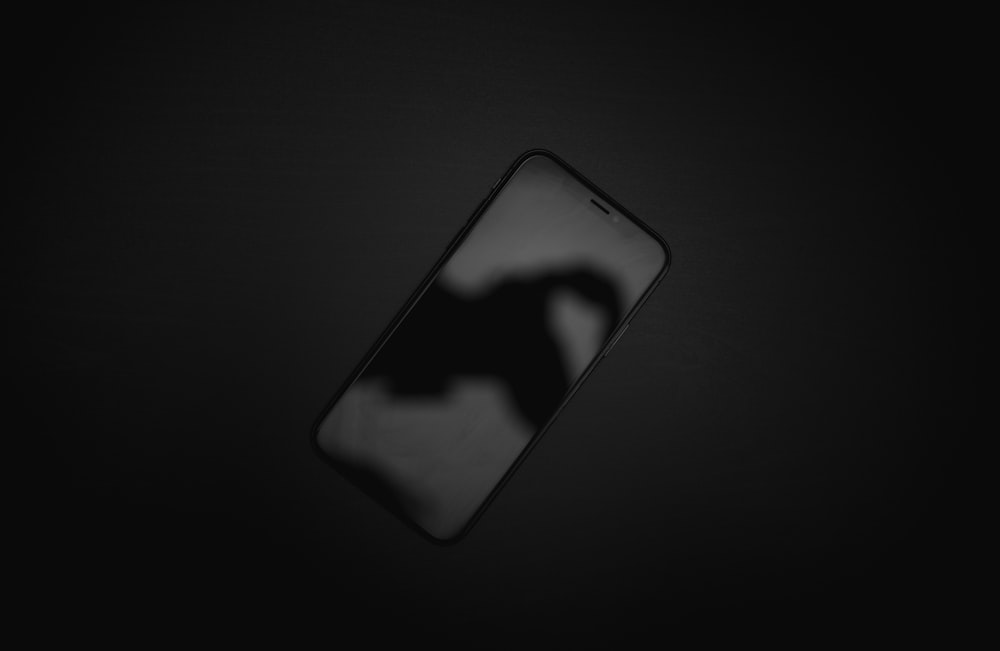 black iphone 5 on black textile