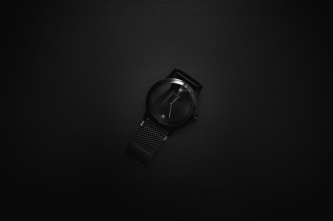 silver round analog watch with black strap