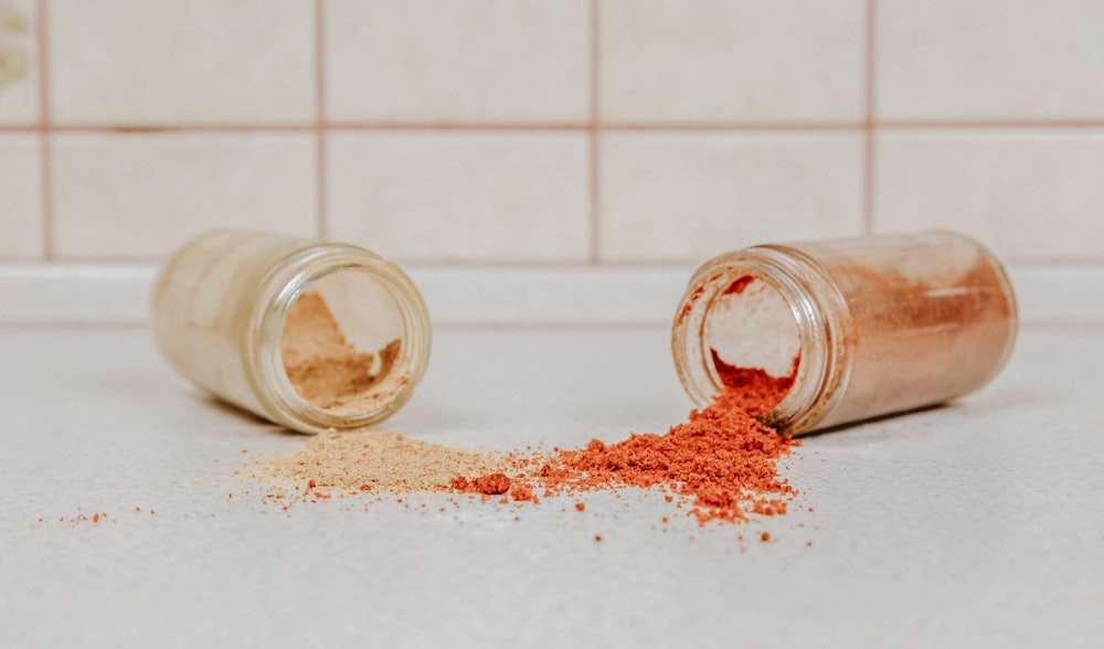 clear glass jar with red powder