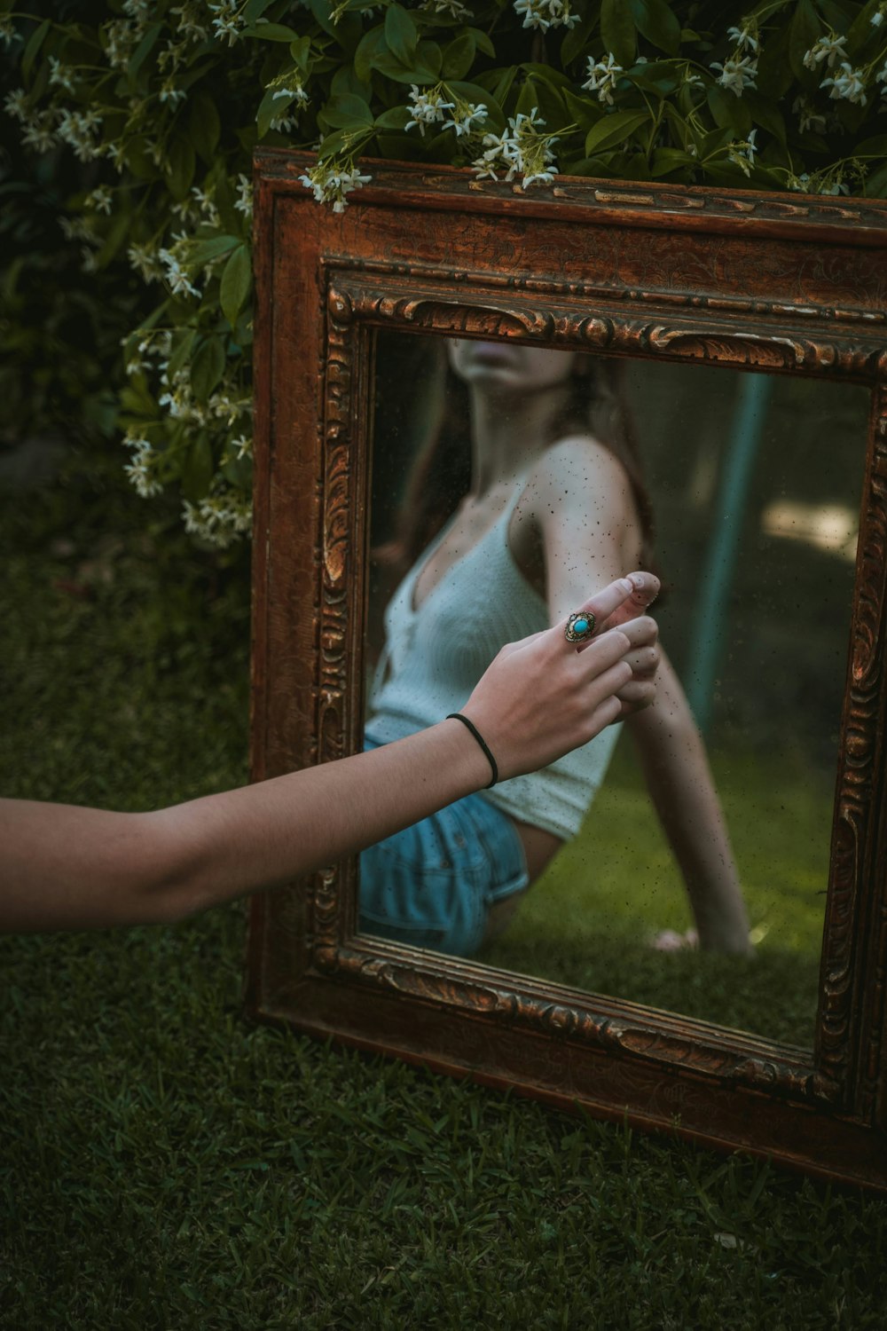 person holding brown wooden frame