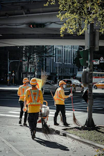 people in orange coat walking on sidewalk during daytime
