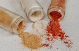 Fine copper powder spilling gently from a container.