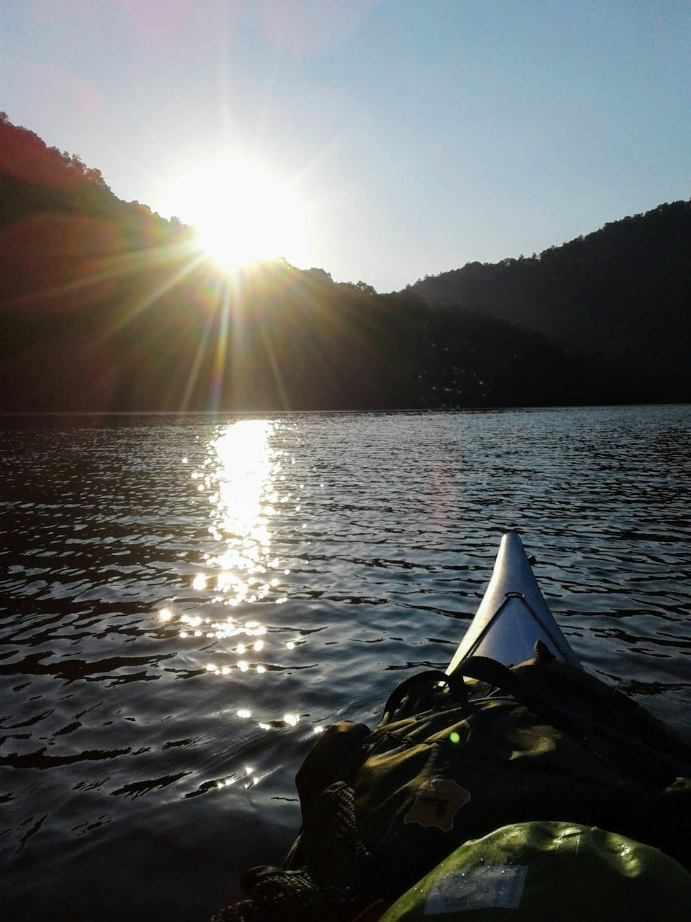 body of water near mountain during daytime