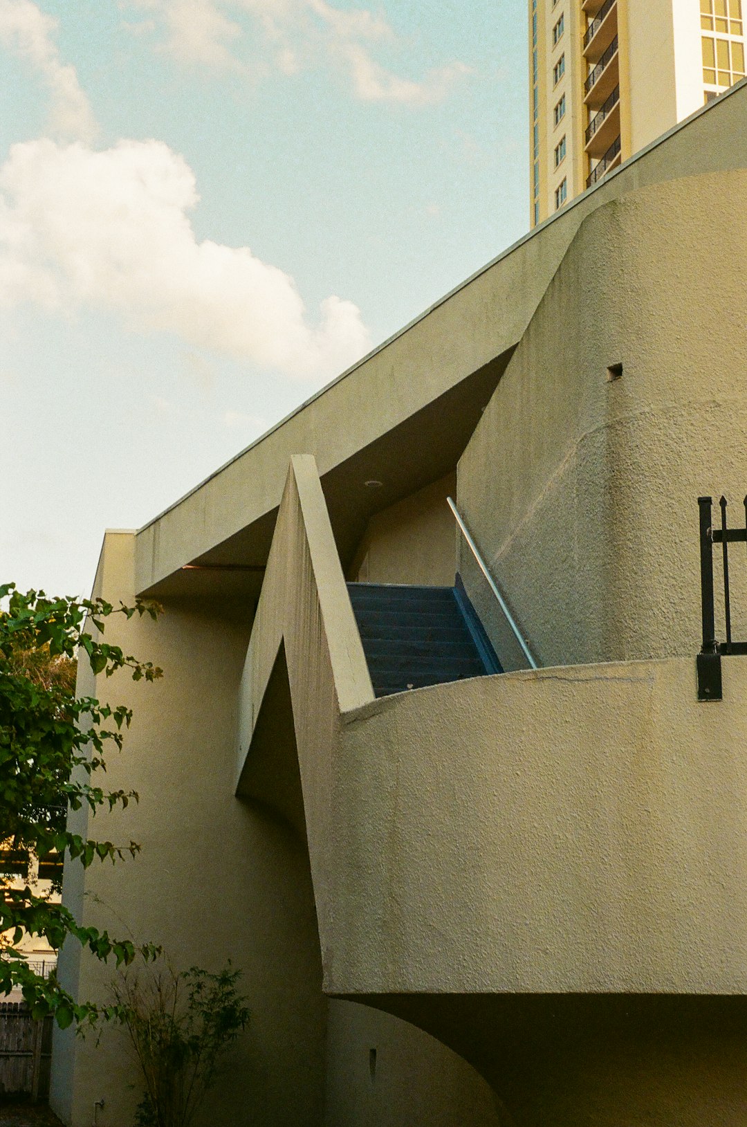 gray concrete building with black metal post