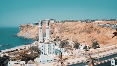 white concrete building near body of water during daytime