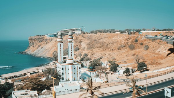 White concrete building near body of water during daytime — Dakar, Senegal