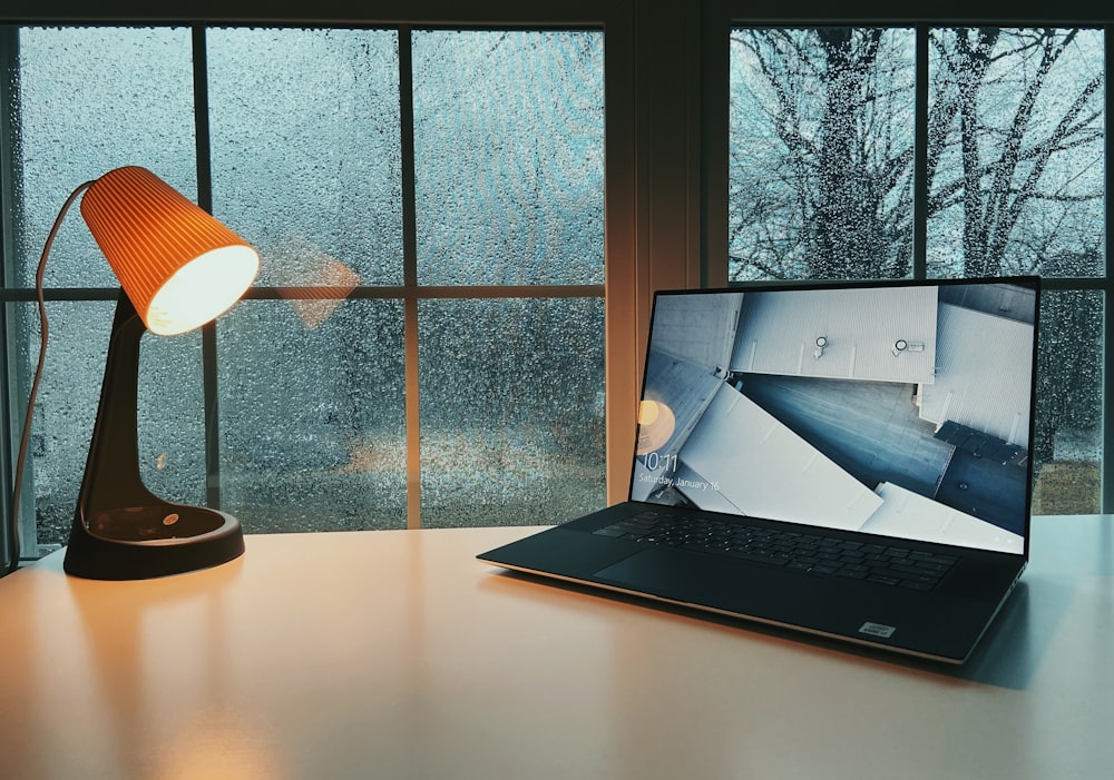 silver macbook on brown wooden table