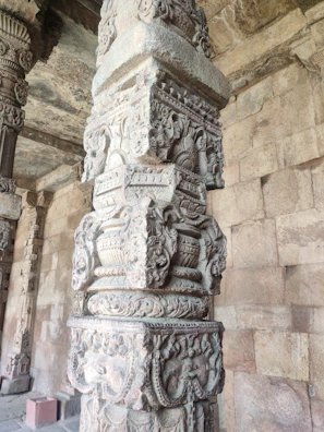 The Ashok Stambh monument subtly displayed on a wall behind a professional workspace.