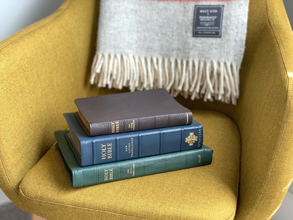 black and green books on yellow textile