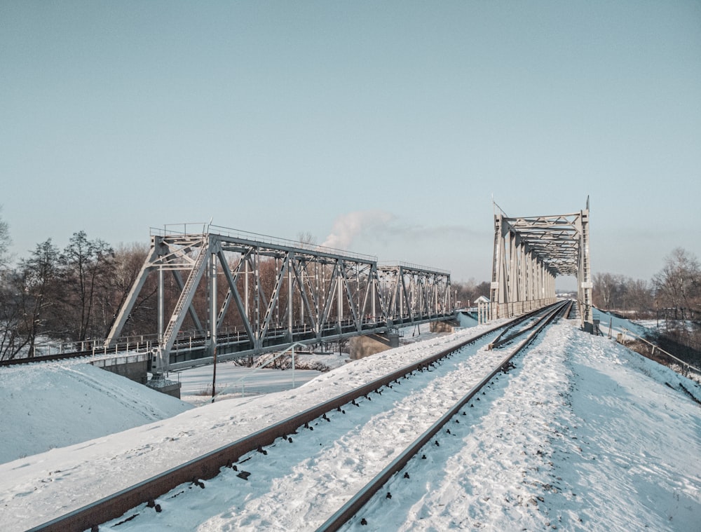 brown wooden bridge over blue body of water during daytime