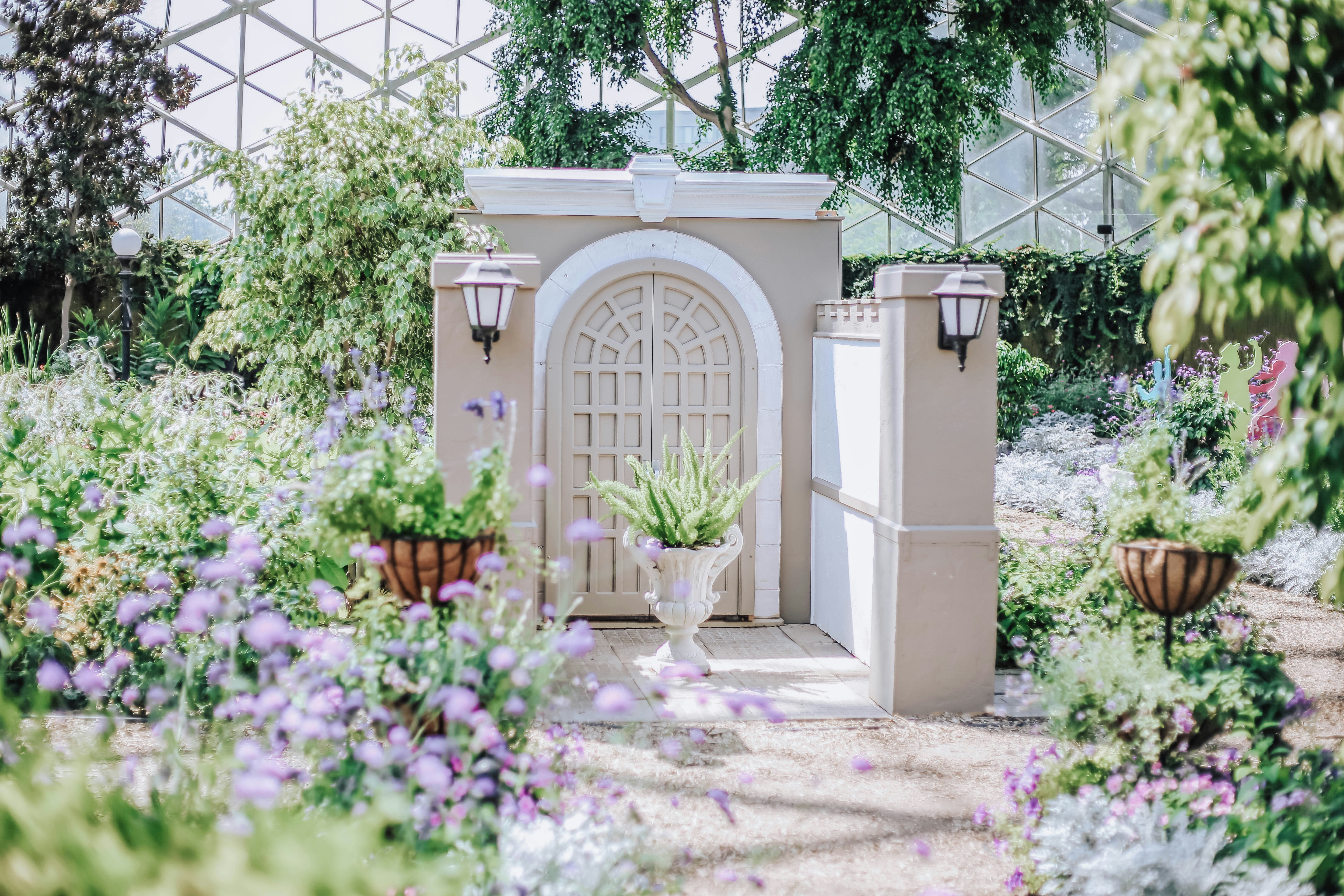 a gateway structure in the middle of a garden