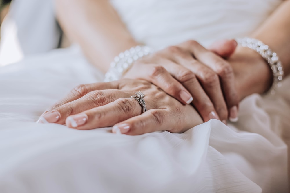 person wearing silver ring on ring finger