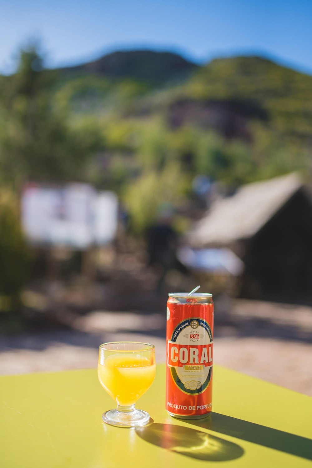 red and yellow can on brown wooden table