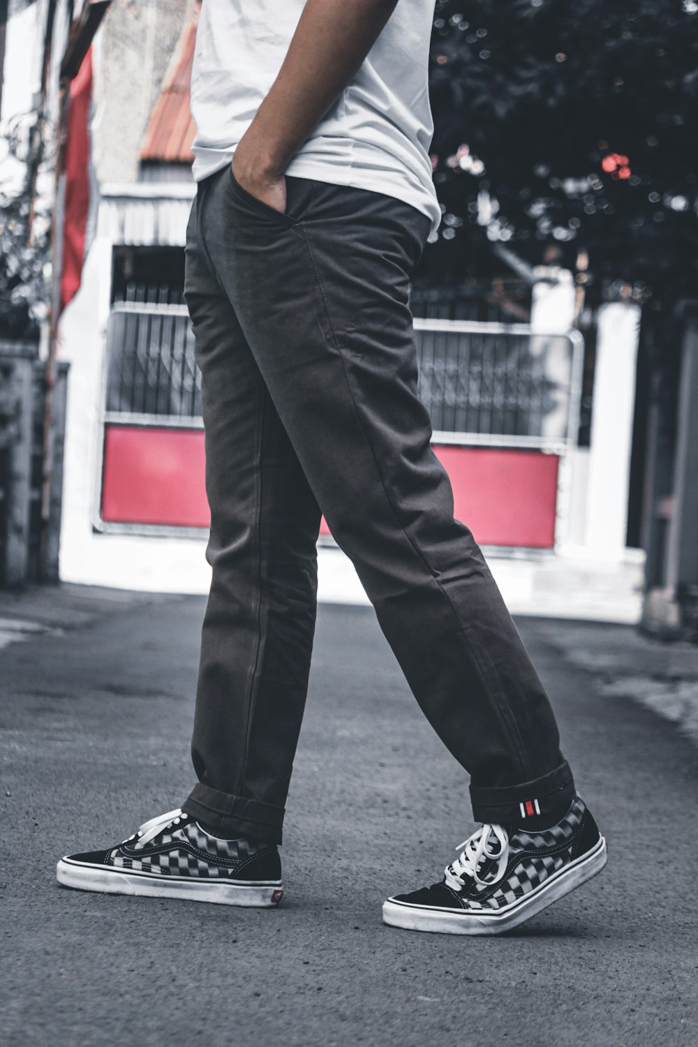 person in black pants and black and white nike sneakers