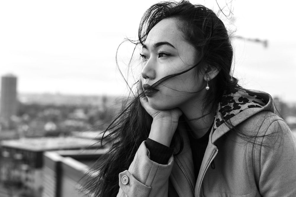 grayscale photo of woman in coat