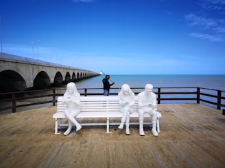 white statue on brown wooden dock during daytime
