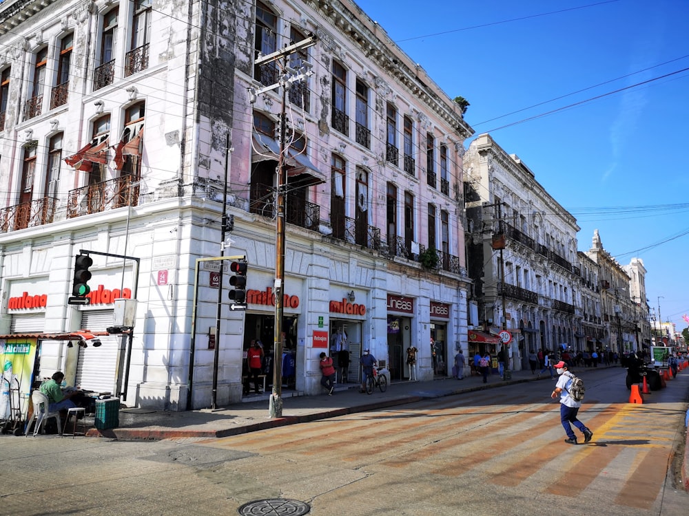 people walking on sidewalk near building during daytime