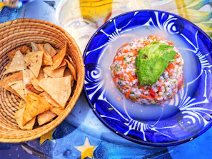 Close-up of a vibrant ceviche with fresh lime and cilantro on a rustic plate